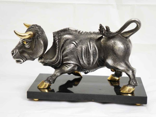 Frank Meisler Bull in silver and gold plated metal with movable head and rear legs. On black marble base.